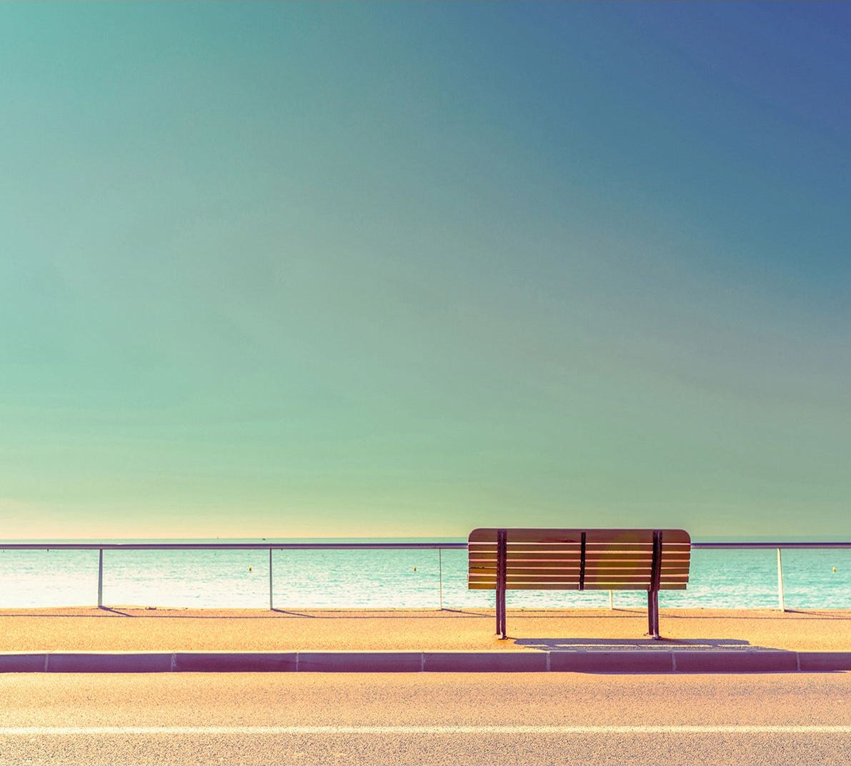 Seaside Serenity: Bench by the Calm Sea Wall Mural