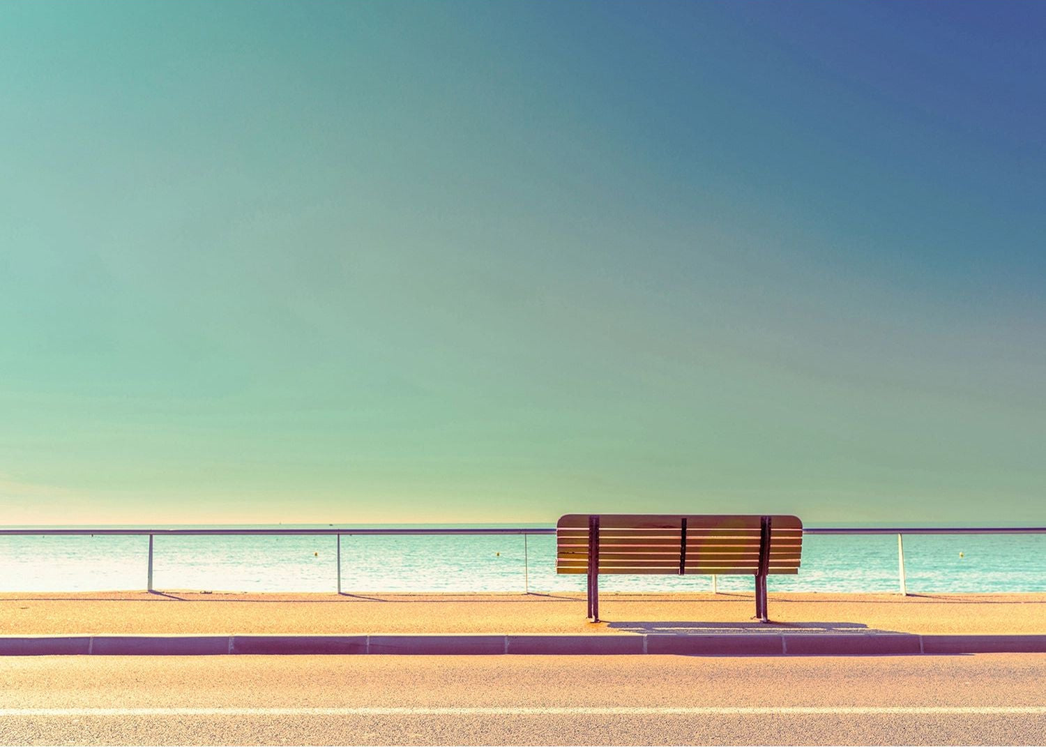 Seaside Serenity: Bench by the Calm Sea Wall Mural