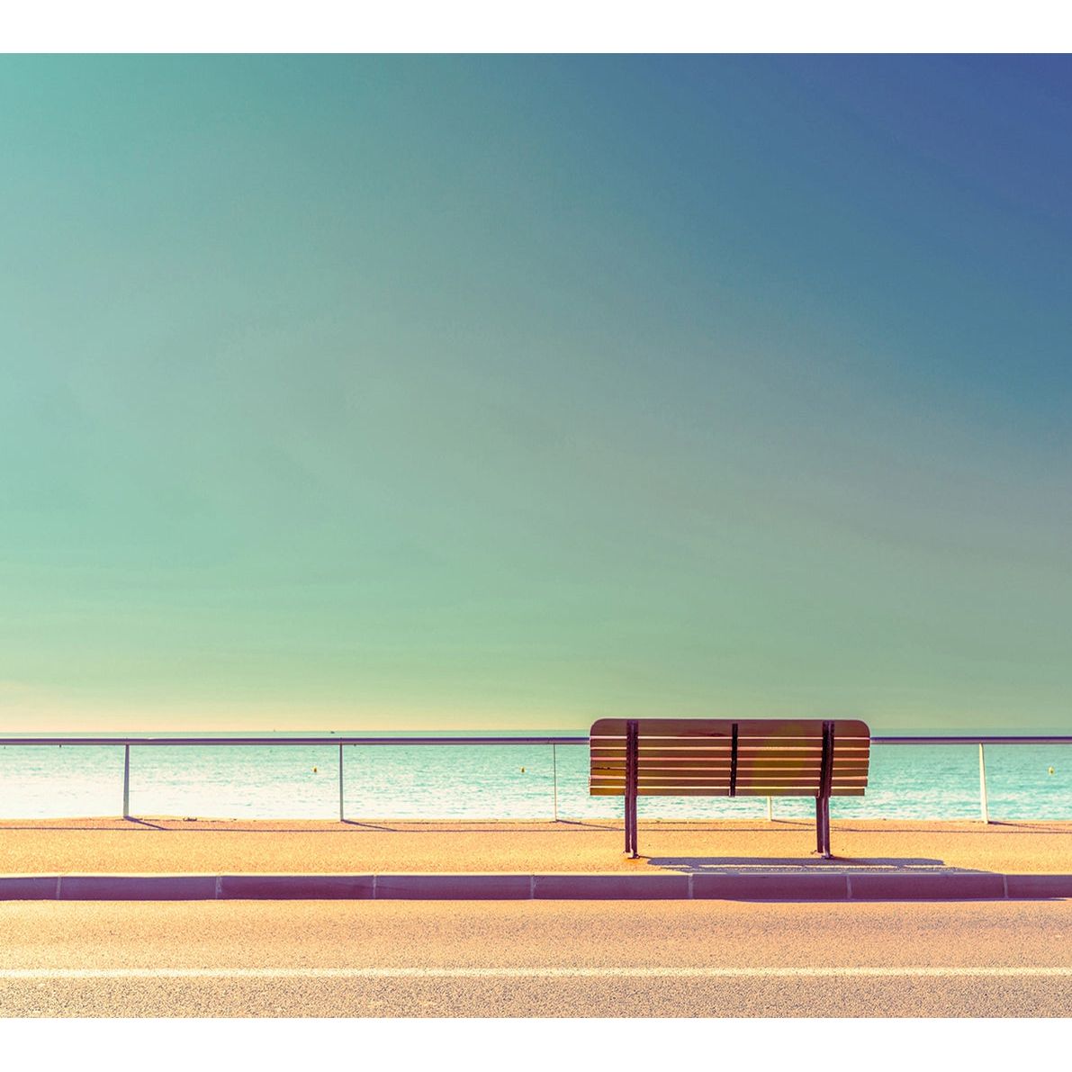 Seaside Serenity: Bench by the Calm Sea Wall Mural